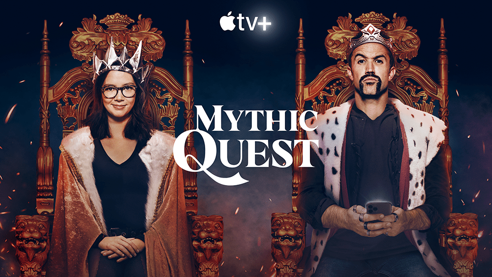 promotional image for the AppleTV show Mythic Quest. Shows a woman (Poppy) dressed as a fantasy queen on a throne on the left and a man (Iain) dressed as a king on the right holding a cell phone.